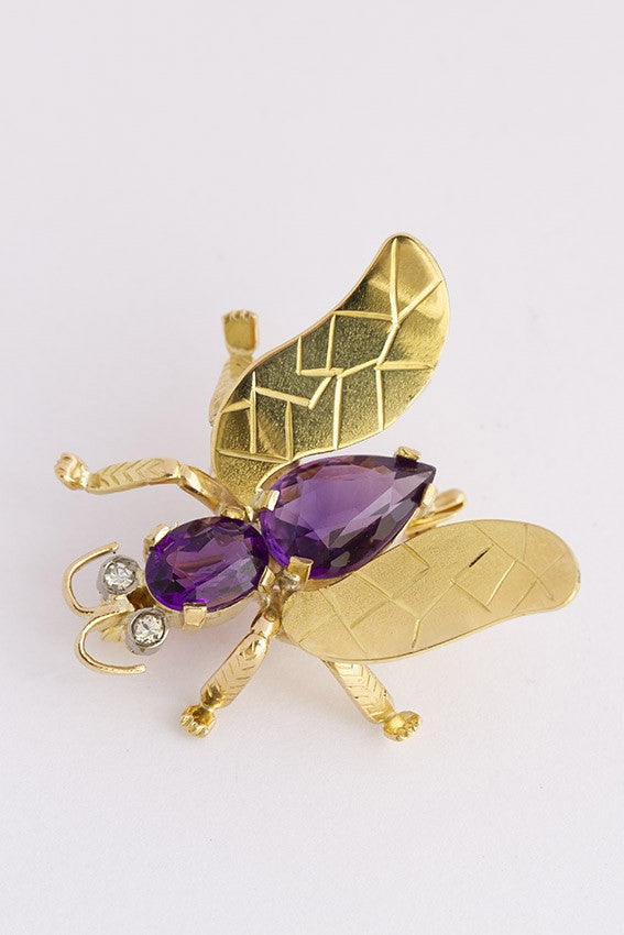 Golden insect brooch with amethyst and diamond