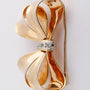 Gold bow brooch with 5 diamonds