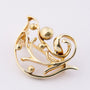Golden bird brooch