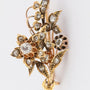 Gold flower brooch with rose-cut diamonds set in silver