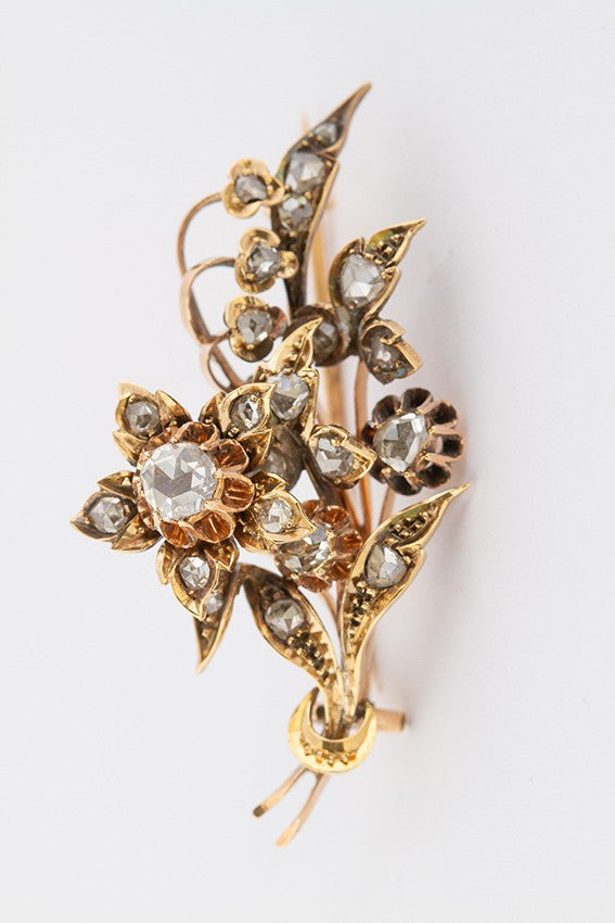Gold flower brooch with rose-cut diamonds set in silver