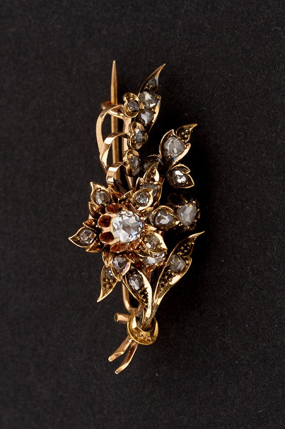 Gold flower brooch with rose-cut diamonds set in silver