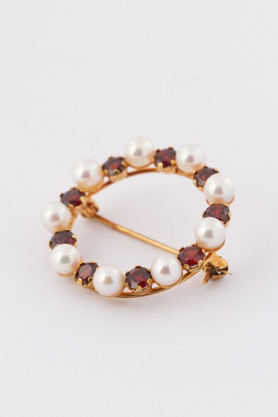 Gold openwork brooch with garnets and cultured pearls