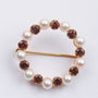 Gold openwork brooch with garnets and cultured pearls