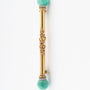 Gold brochette with amazonite and white enamel