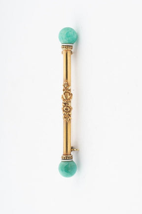 Gold brochette with amazonite and white enamel