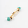 Gold brochette with amazonite and white enamel