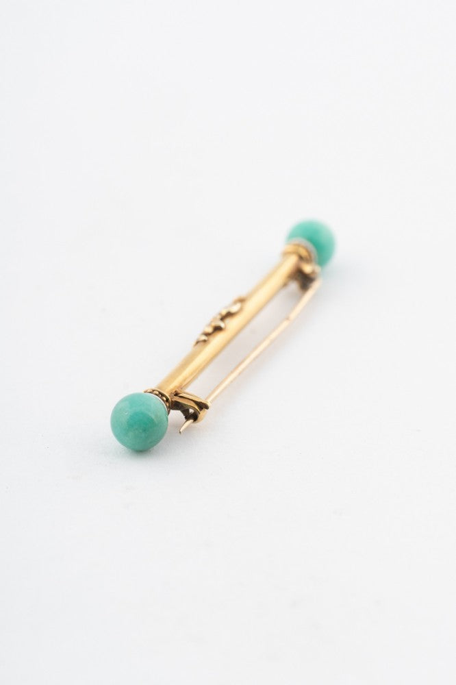 Gold brochette with amazonite and white enamel