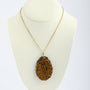 Tiger's eye pendant on a gold necklace