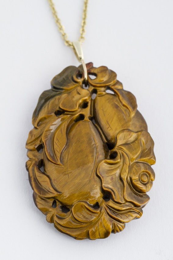 Tiger's eye pendant on a gold necklace