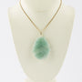 Jade pendant on gold necklace