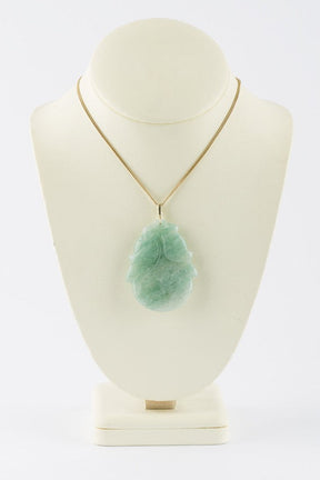 Jade pendant on gold necklace