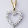 Gold heart pendant with diamonds on a gold necklace
