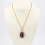 Gold entourage pendant with pearls and amethyst on a cord necklace