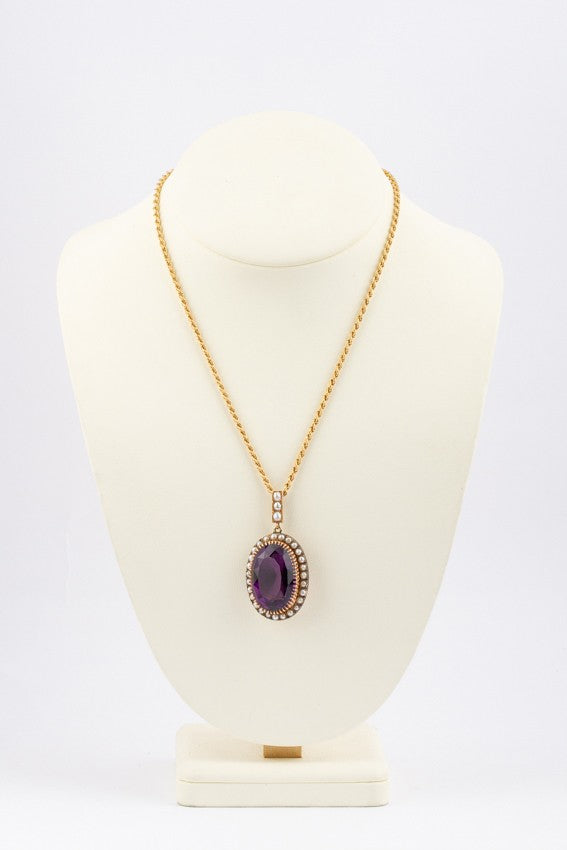 Gold entourage pendant with pearls and amethyst on a cord necklace