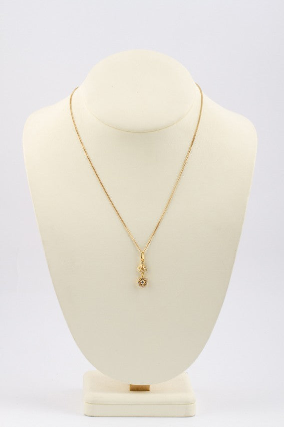Gold entourage pendant with diamonds on a gold necklace