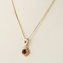 Gold pendant with garnet on gold necklace