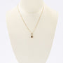 Gold pendant with garnet on gold necklace