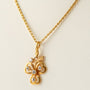 Gold three-leaf clover pendant with diamonds on a gold necklace
