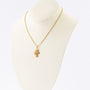 Gold three-leaf clover pendant with diamonds on a gold necklace