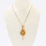 Gold traditional costume pendant on gold necklace