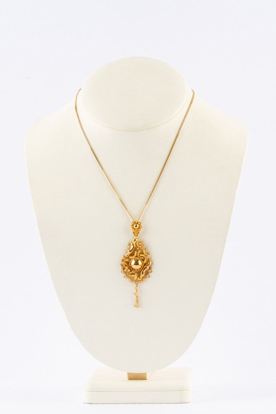 Gold traditional costume pendant on gold necklace