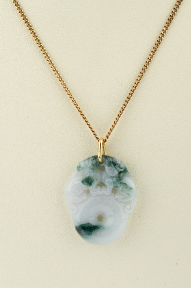 Jade lucky pendant with two monkeys on a gold necklace