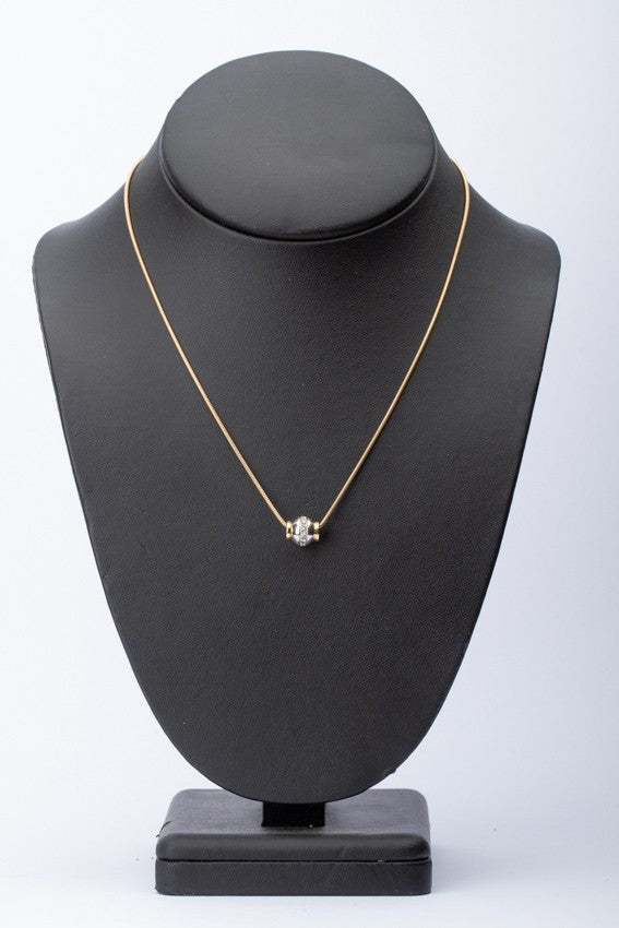 White/yellow gold pendant set with diamonds on a gold necklace