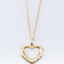 Gold heart pendant with diamonds on a gold necklace