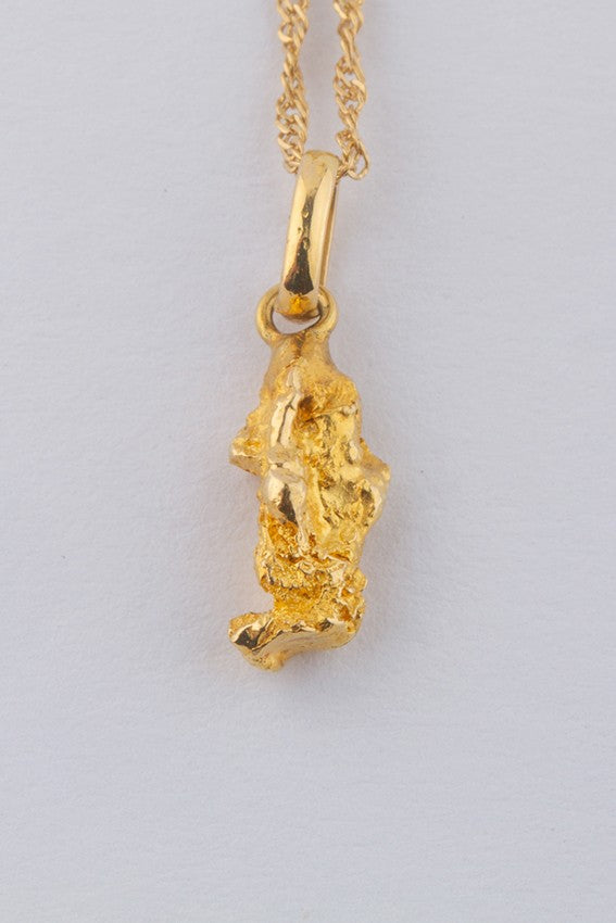 Gouden nugget hanger aan gouden collier