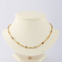 Gouden schakel collier met diverse edelstenen.