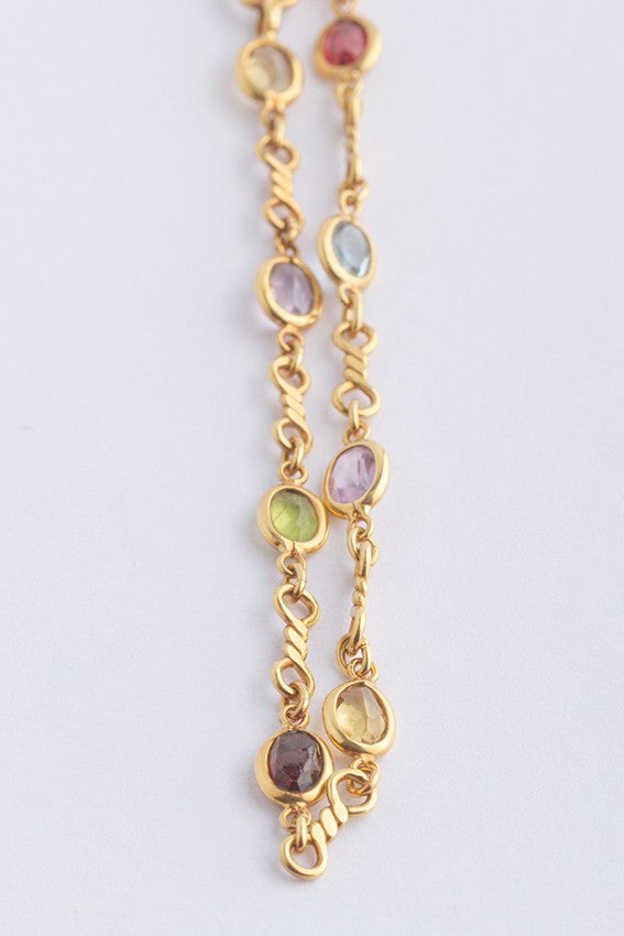 Gouden schakel collier met diverse edelstenen.