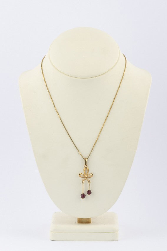 Gouden strik hanger met granaten