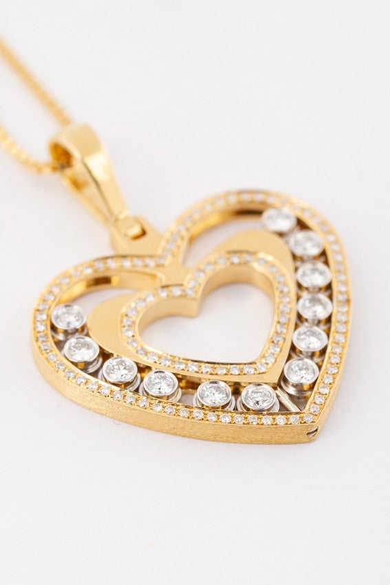 Gold heart pendant with 120 diamonds on a gold necklace