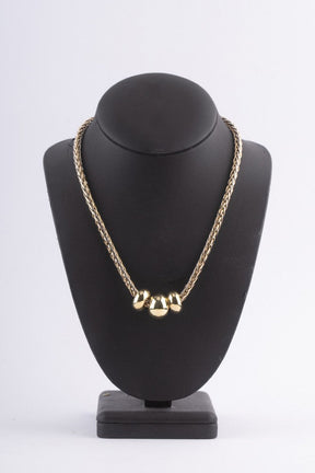 Wit/geel gevlochten collier met 3 gouden ringen