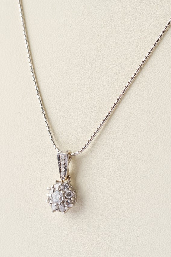 White gold pendant with 12 diamonds on a white gold necklace