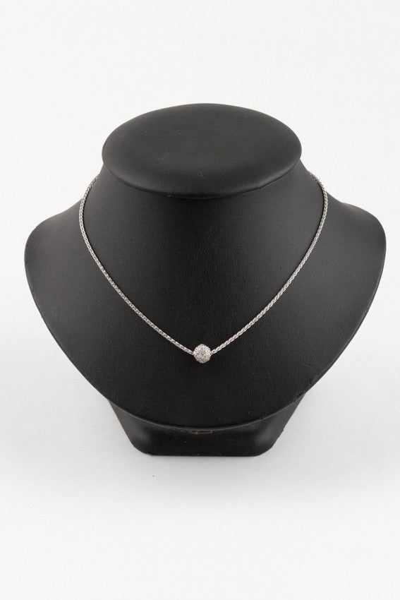 White gold pendant on a white gold braided necklace