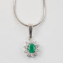 White gold entourage pendant with emerald and diamonds on a white gold necklace