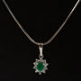 White gold entourage pendant with emerald and diamonds on a white gold necklace