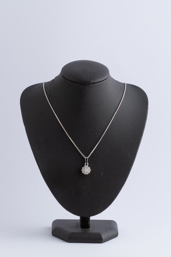 White gold double entourage pendant with diamonds on a white gold necklace