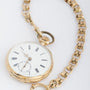 Antique gold pocket watch on watch chain