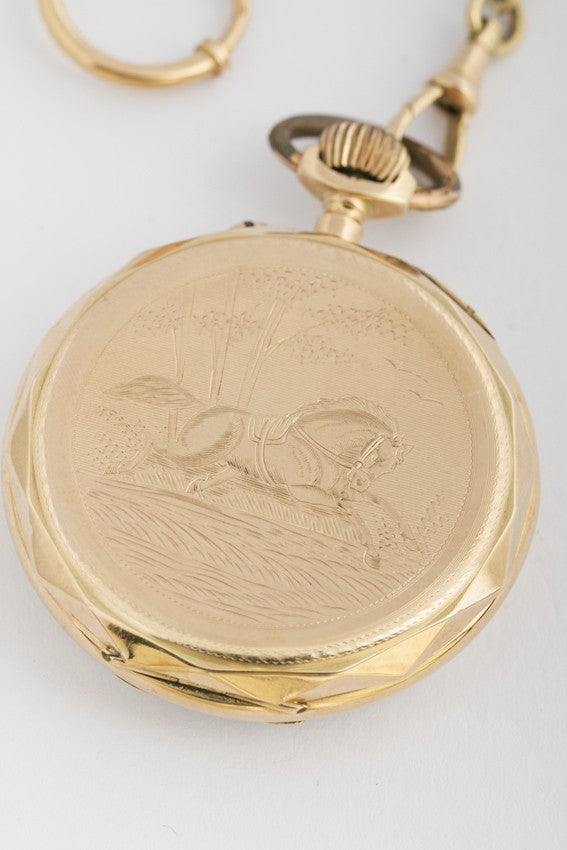 Antique gold pocket watch on watch chain
