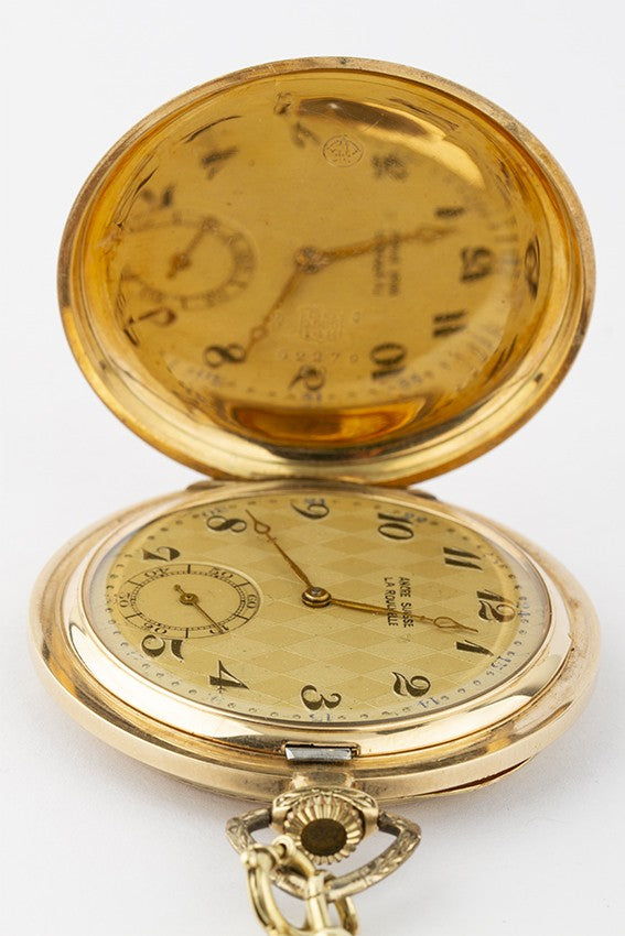 Gold savonette on gold watch chain