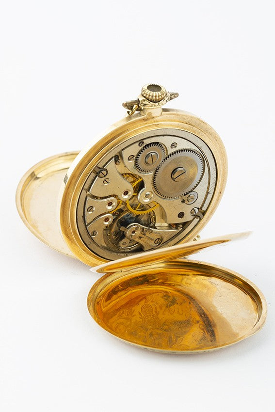 Gold savonette on gold watch chain