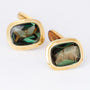 Gold cufflinks, each with a tourmaline