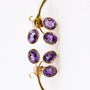 Gold stud earrings with amethysts in each one