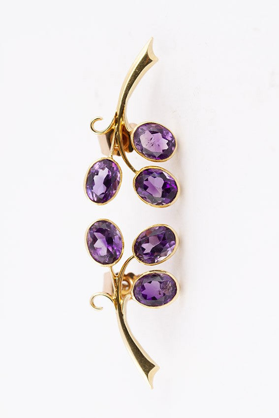 Gold stud earrings with amethysts in each one