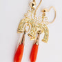 Gold earrings with a red coral