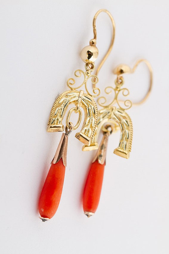 Gold earrings with a red coral