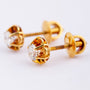20 carat gold solitaire earrings, each with a brilliant